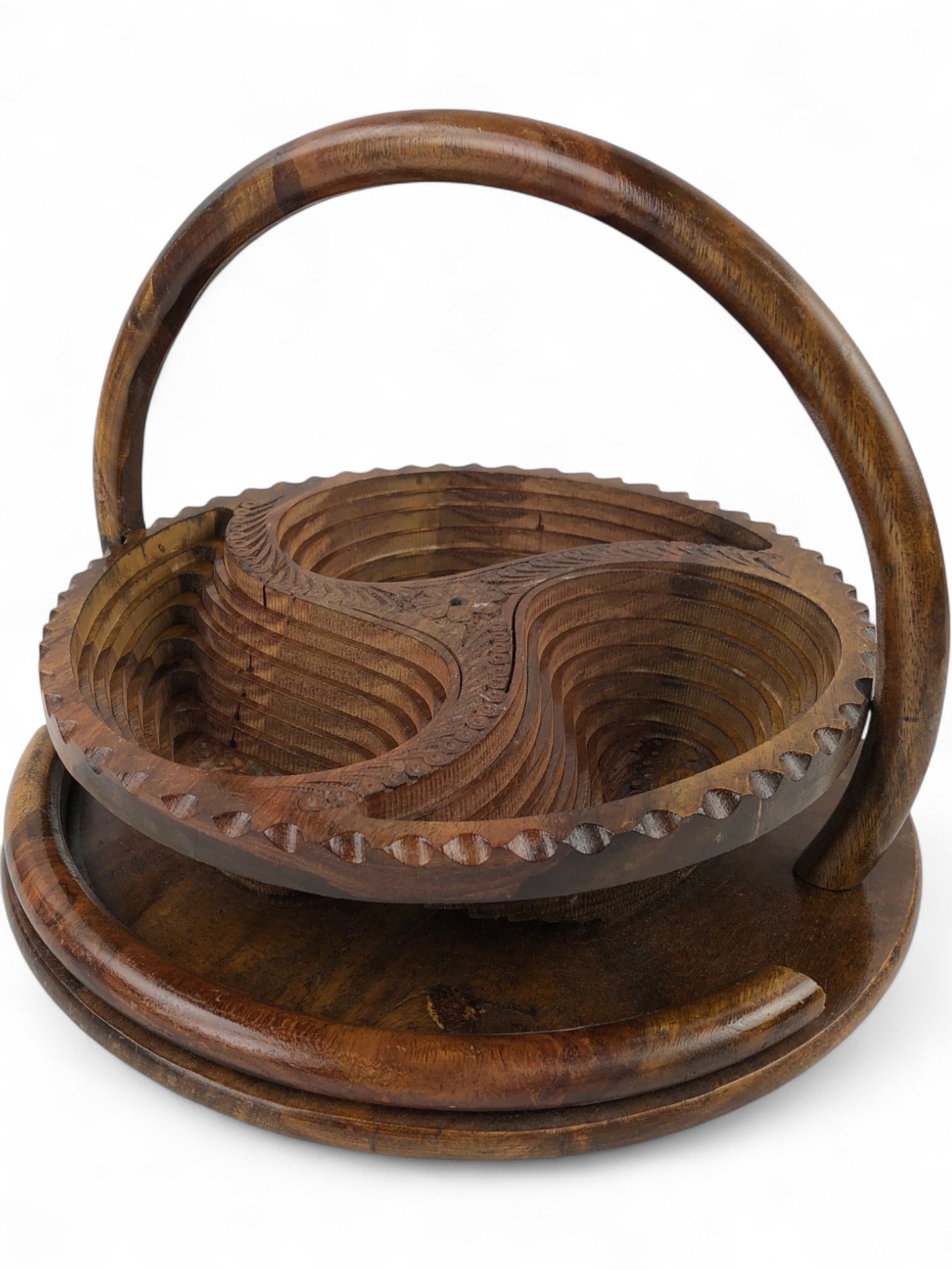 Hand-Carved Folding Wooden Fruit Basket: A hand-carved wooden folding fruit basket featuring a unique three-compartment design with paisley-shaped cutouts. The basket collapses into a flat decorative trivet or base. It features a sturdy