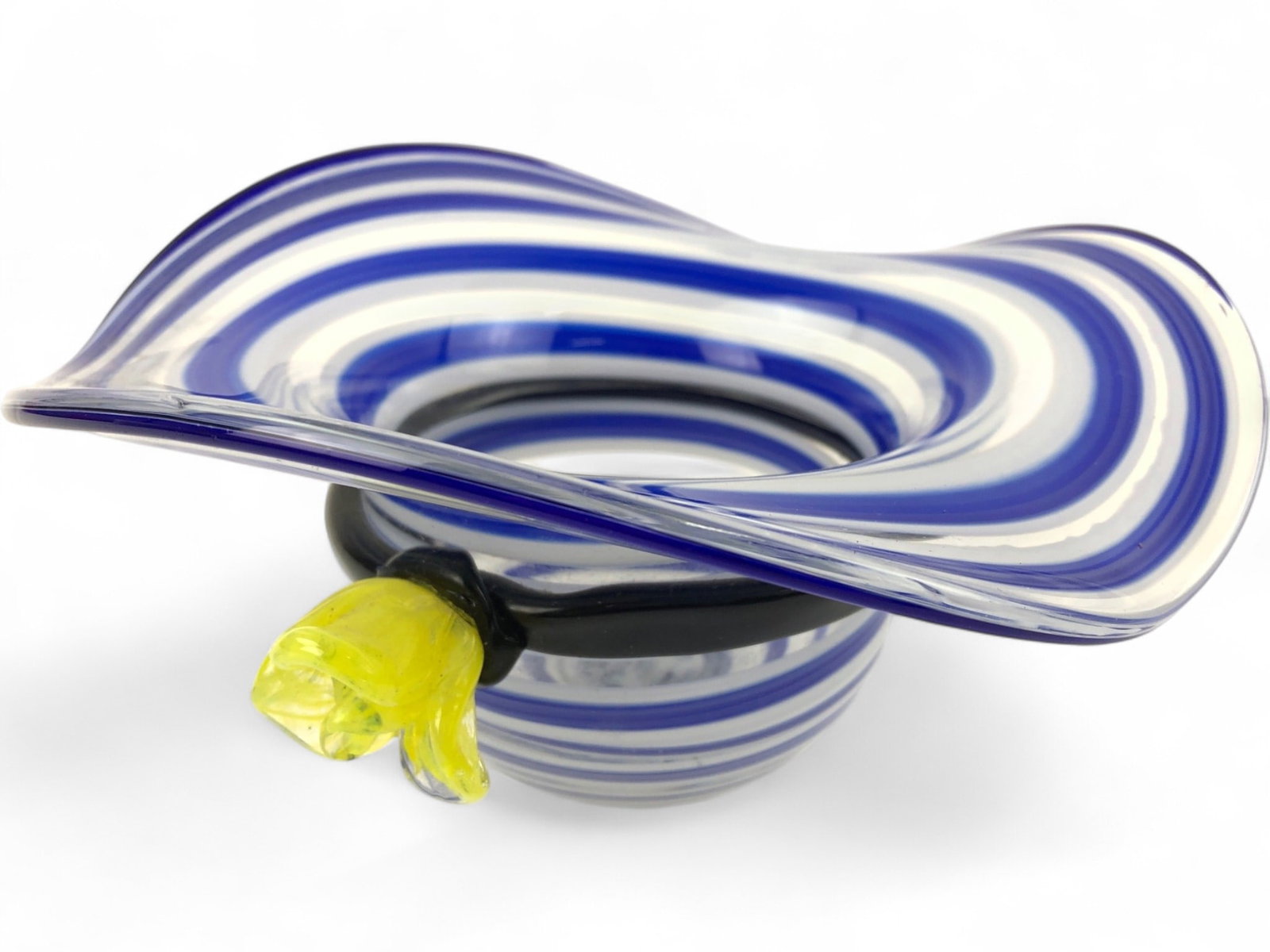 Block Crystal Mouth Blown Art Glass Hat Bowl: A mouth-blown and hand-polished art glass bowl shaped like a floppy sun hat, produced by Block Crystal. Features a blue and white spiral stripe pattern with a black glass band and a yellow applied