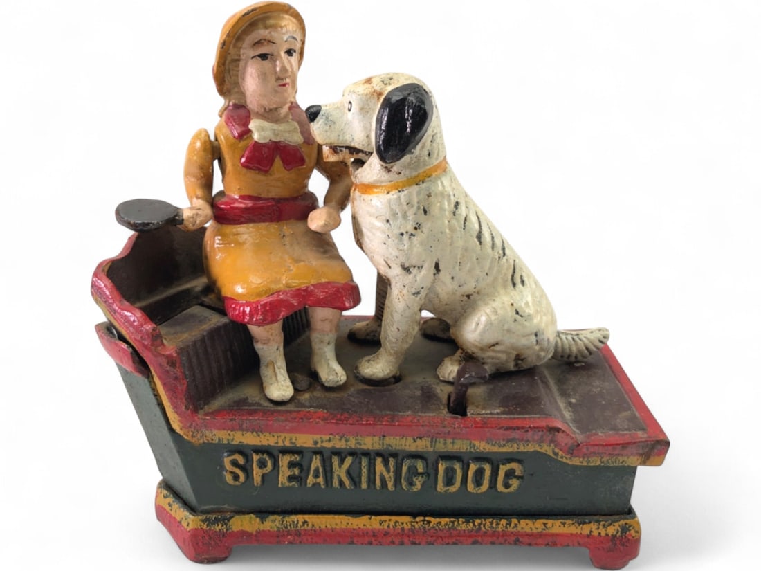 Cast Iron Speaking Dog Mechanical Bank: Cast iron mechanical coin bank, depicting a girl feeding a dog. Features 'SPEAKING DOG' and 'BANK' text on the base. Mechanical action for coin deposit. Shows paint wear and patina. Marked 'CHINA' on 