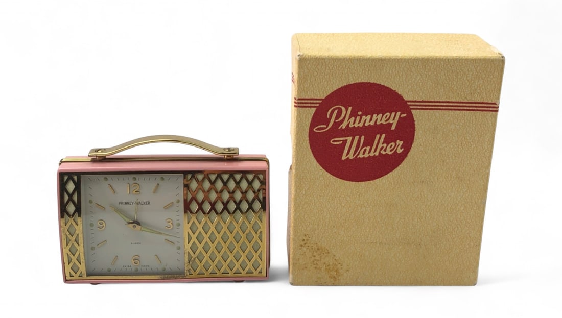 Phinney-Walker Pink Purse Mechanical Alarm Clock: Vintage Phinney-Walker mechanical alarm clock in a pink purse-style case with gold-tone accents and a musical alarm. Features a Swiss-made movement, luminous hands, and a lattice-patterned grille. Inc