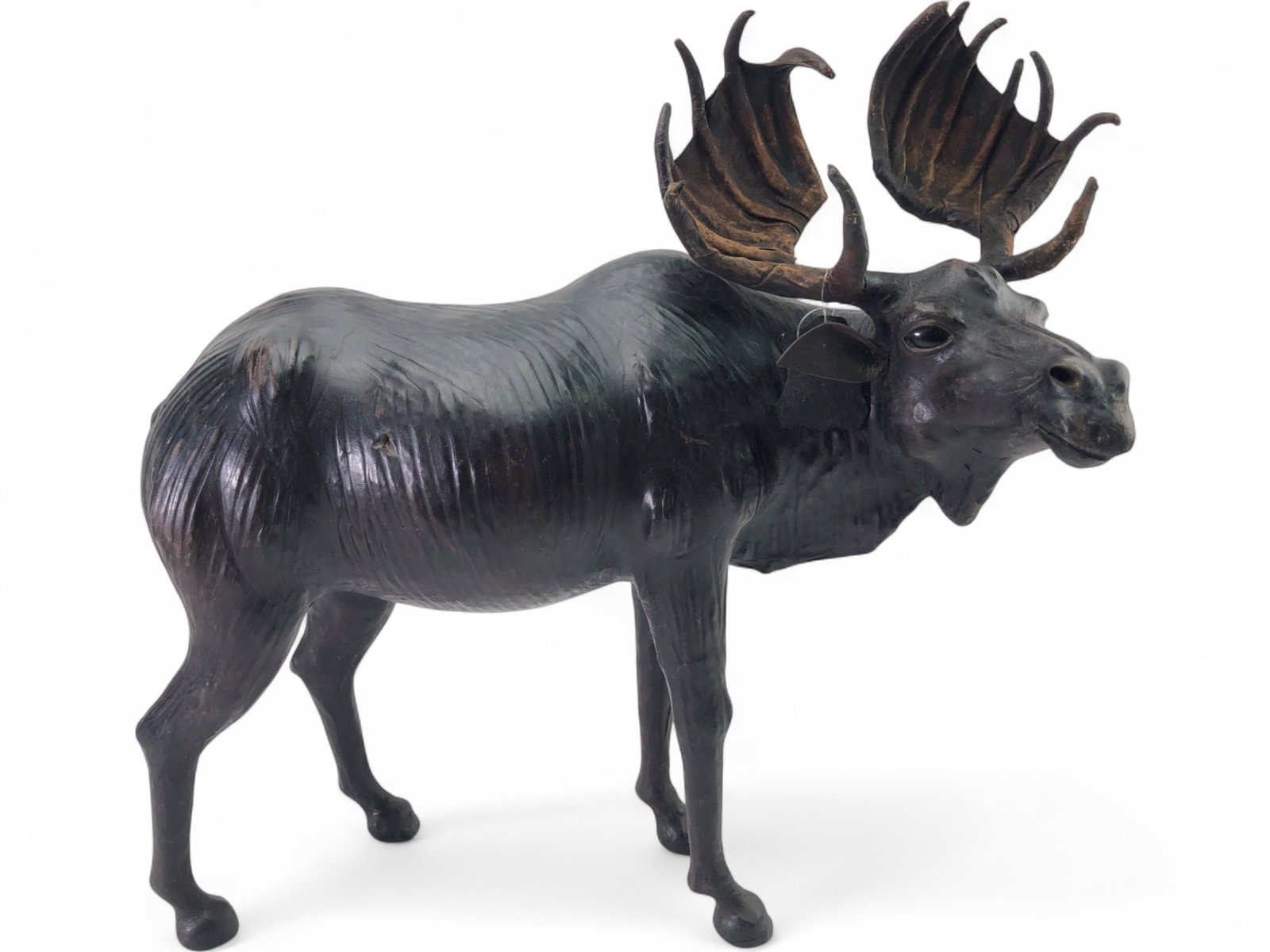 Genuine Leather Moose Figurine Made in India: A large standing moose figurine crafted from genuine black leather over a structured form. Features realistic anatomical detailing, textured surface, and large palmate antlers. Includes original 'Genu