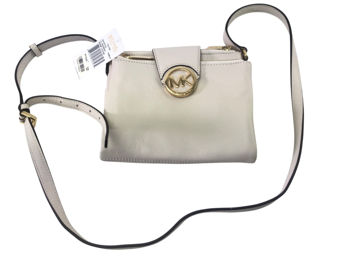Michael Kors Leather LG Crossbody Bag: Michael Kors Fulton LG Crossbody bag in vanilla genuine leather. Features adjustable crossbody strap, top zip closure, interior card slots, and iconic gold-tone MK logo emblem. Branded zipper pull. Ne