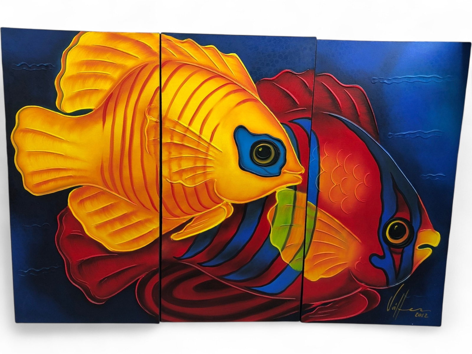 Signed Triptych Tropical Fish Oil Painting: A vibrant three-panel triptych oil on canvas painting depicting two stylized tropical fish in shades of yellow, red, and blue. The artwork features heavy impasto or raised texture on the scales and fi