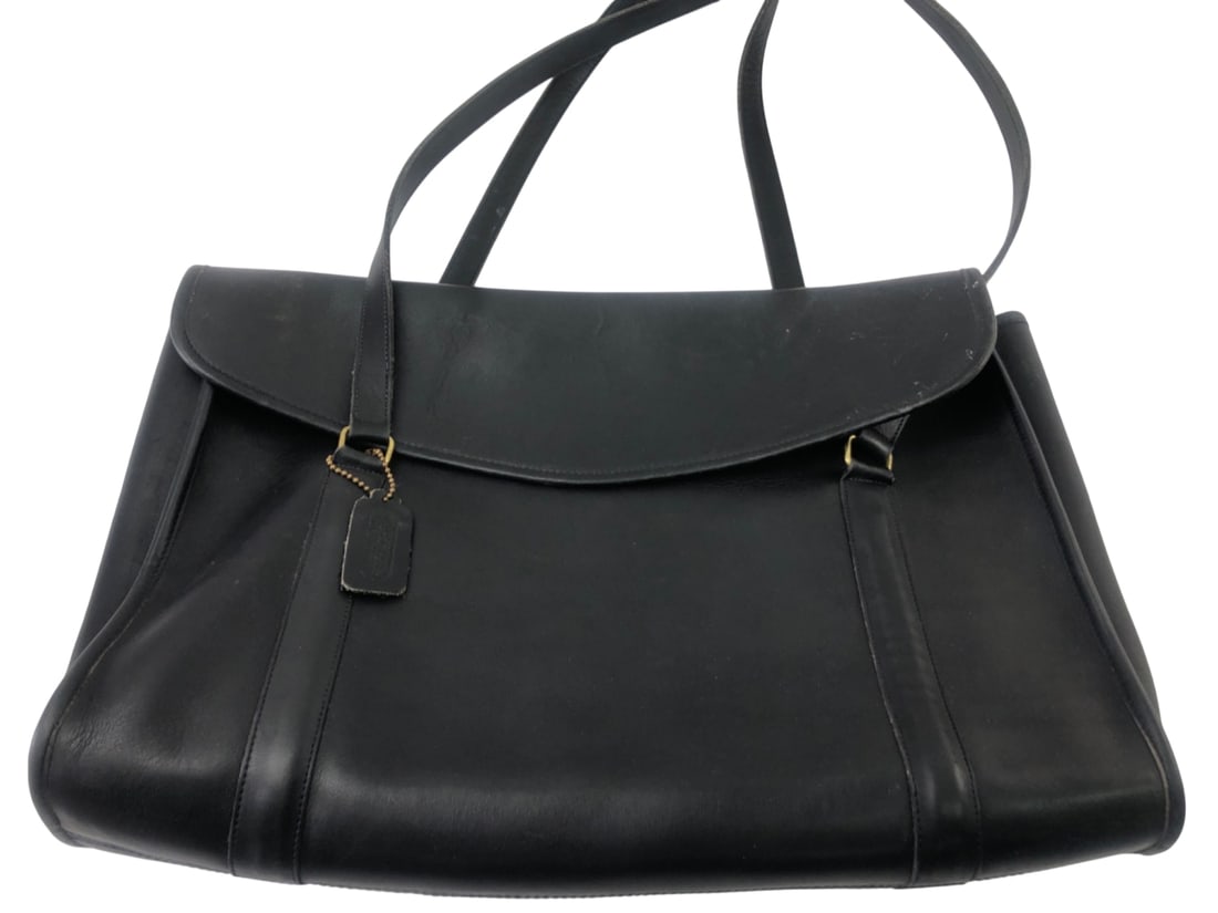 Coach Black Leather Station Bag, Style 1014: Vintage Coach black glove-tanned cowhide leather flap shoulder bag, style 1014, also known as the Station Bag. Features a top flap closure, dual shoulder straps, gold-tone hardware, and an interior zi
