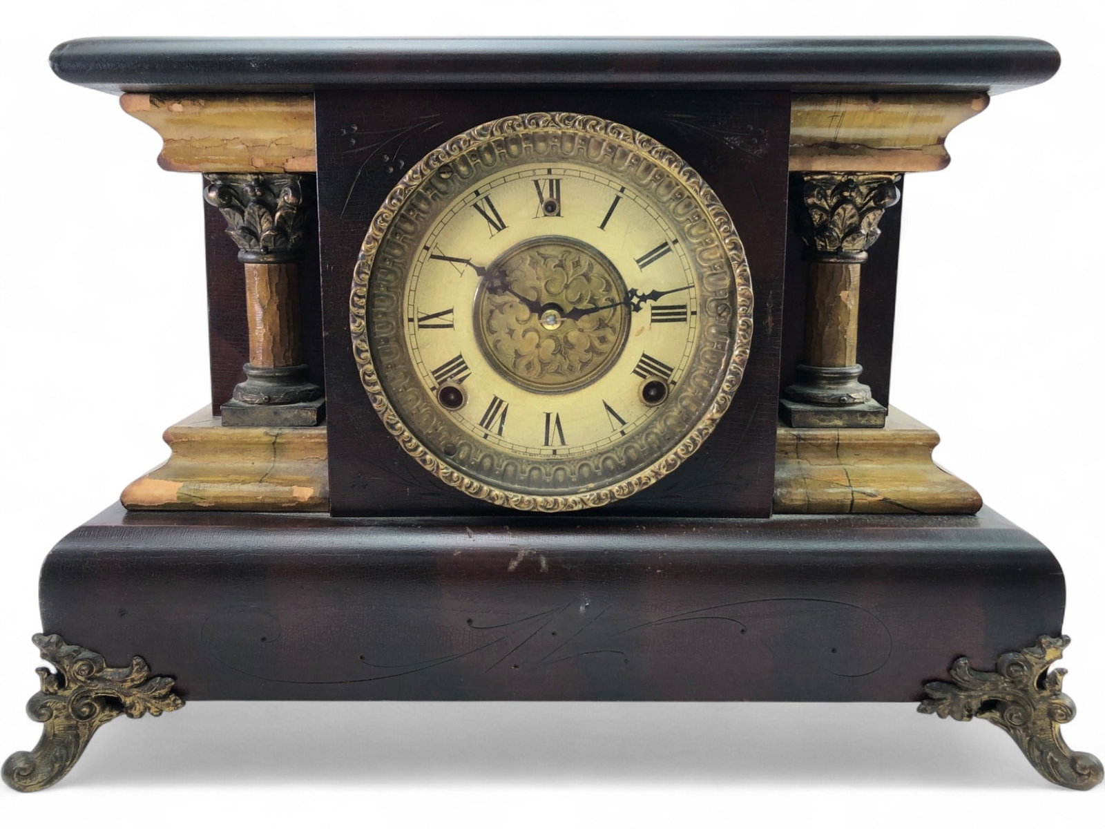 Wm. L. Gilbert Clock Co. Mantel Clock: Victorian-style mantel clock by Wm. L. Gilbert Clock Co., Winsted, Conn. Features a dark wood case with faux-marbleized architectural columns and trim, ornate brass-tone dial with Roman numerals, and 
