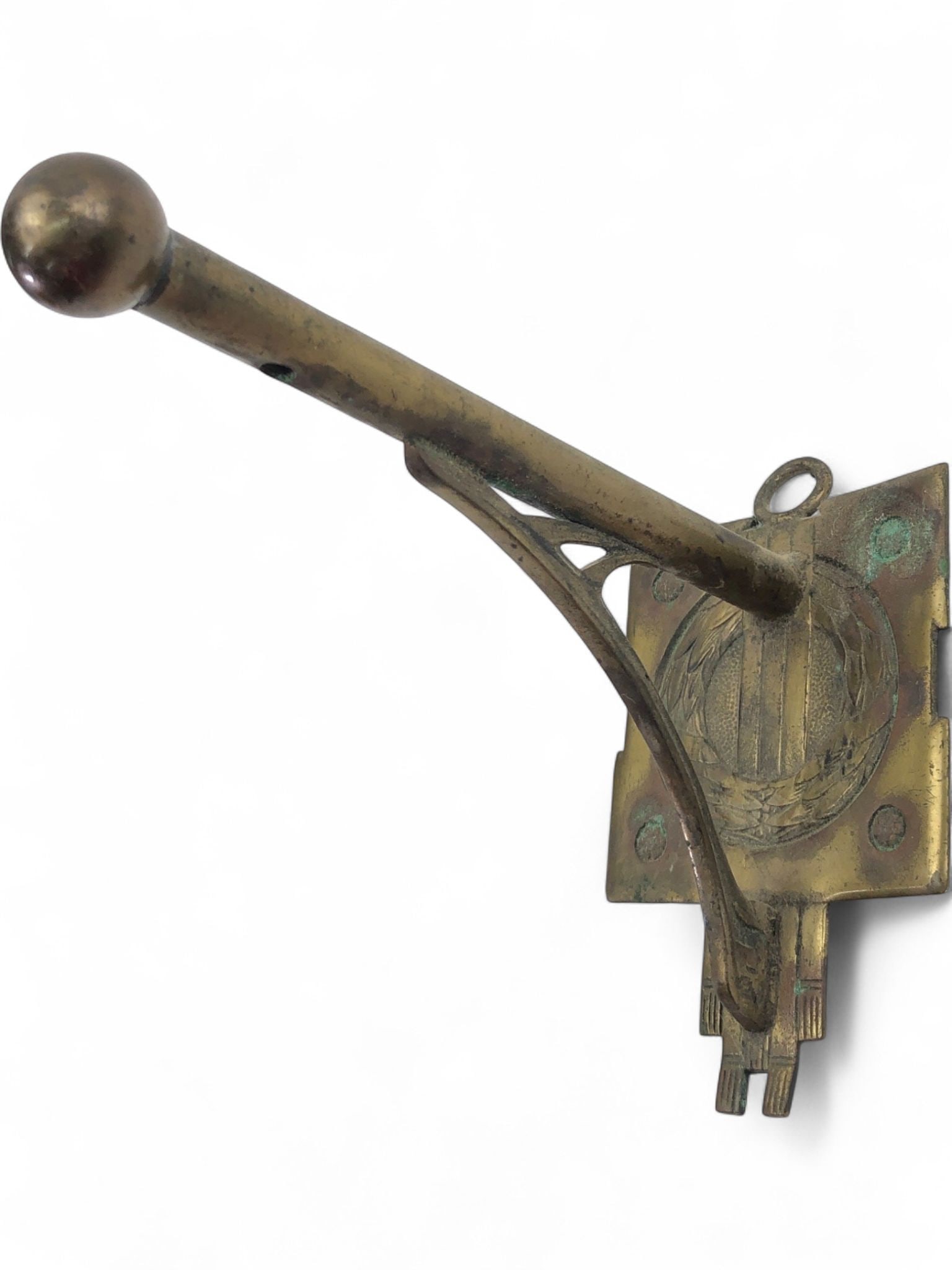 Art Deco Brass Wall Hook with Laurel Wreath: Art Deco style wall-mounted hook, likely brass or bronze with a natural aged patina and areas of green oxidation. The backplate features a cast laurel wreath motif and geometric stepped detailing at t