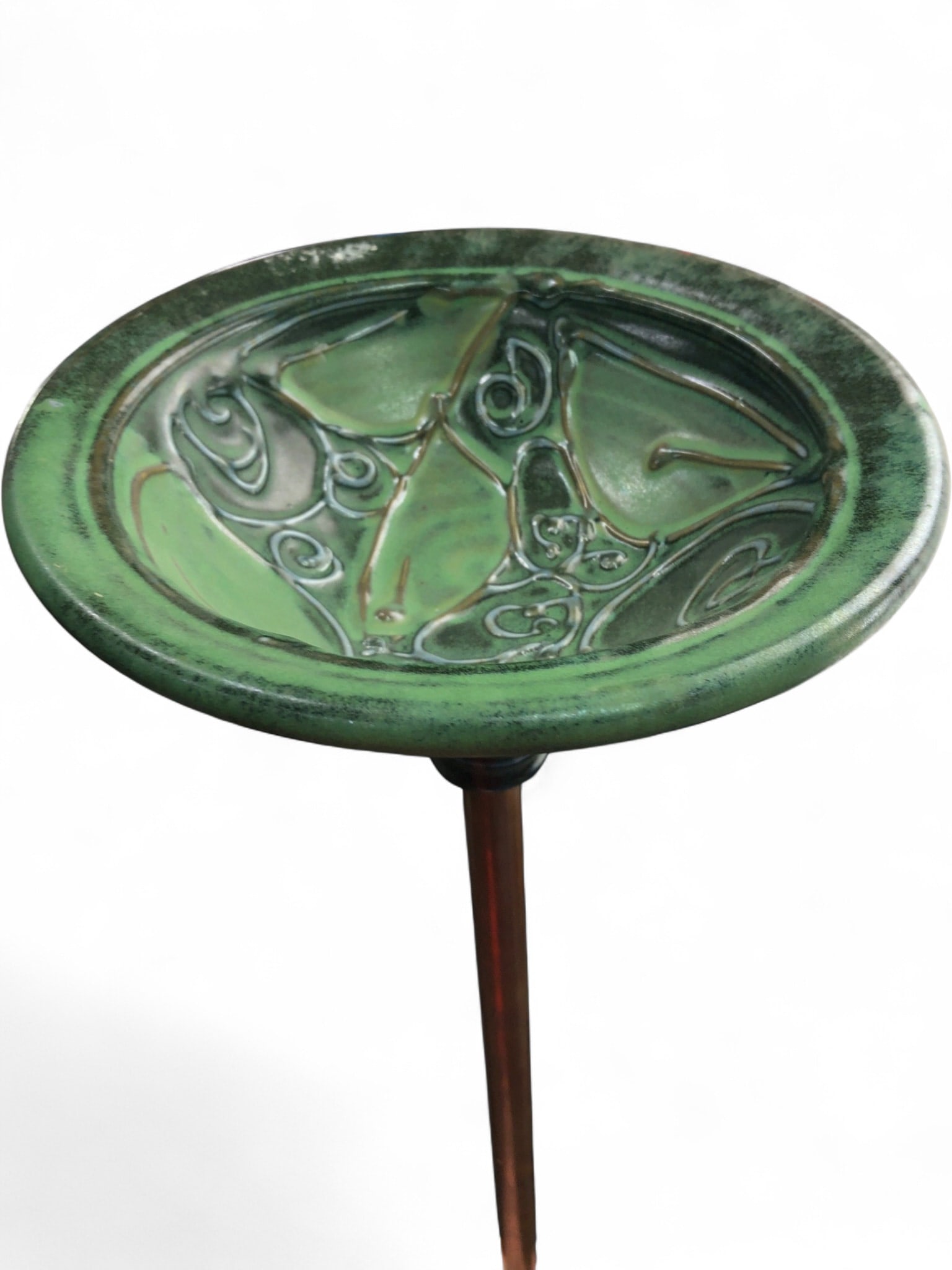 Deb LaPointe Pottery and Copper Yard Art: Handcrafted pottery yard art by Deb LaPointe. Features a green-glazed stoneware dish with incised swirl and leaf motifs, mounted on a copper pipe stake. The dish is signed with a 'DP' mark on the inte