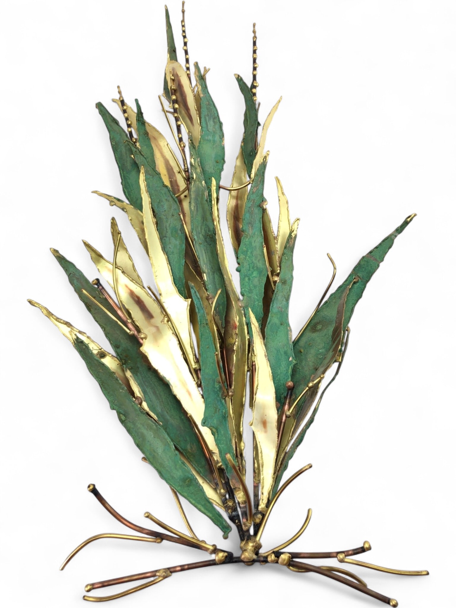 MCM Brutalist Style Signed Metal Wall Sculpture: Mid-Century Modern brutalist style wall sculpture, featuring stylized botanical forms. Constructed from torch-cut and welded brass and copper with a green verdigris patina. The piece features a cluste