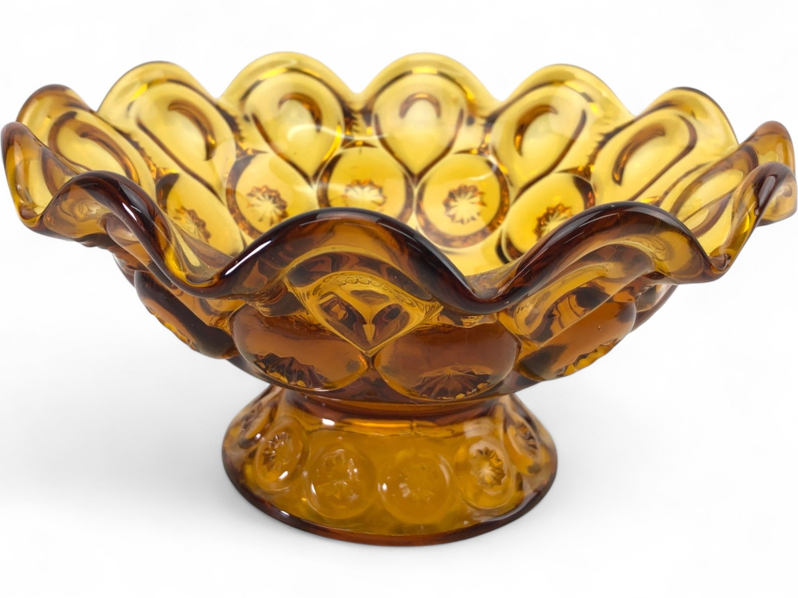 MCM L.E. Smith Moon and Stars Amber Glass Compote: Mid-Century Modern pedestal compote bowl in the popular Moon and Stars pattern, attributed to L.E. Smith. Crafted from pressed amber glass, the bowl features a scalloped, crimped rim and a decorative 