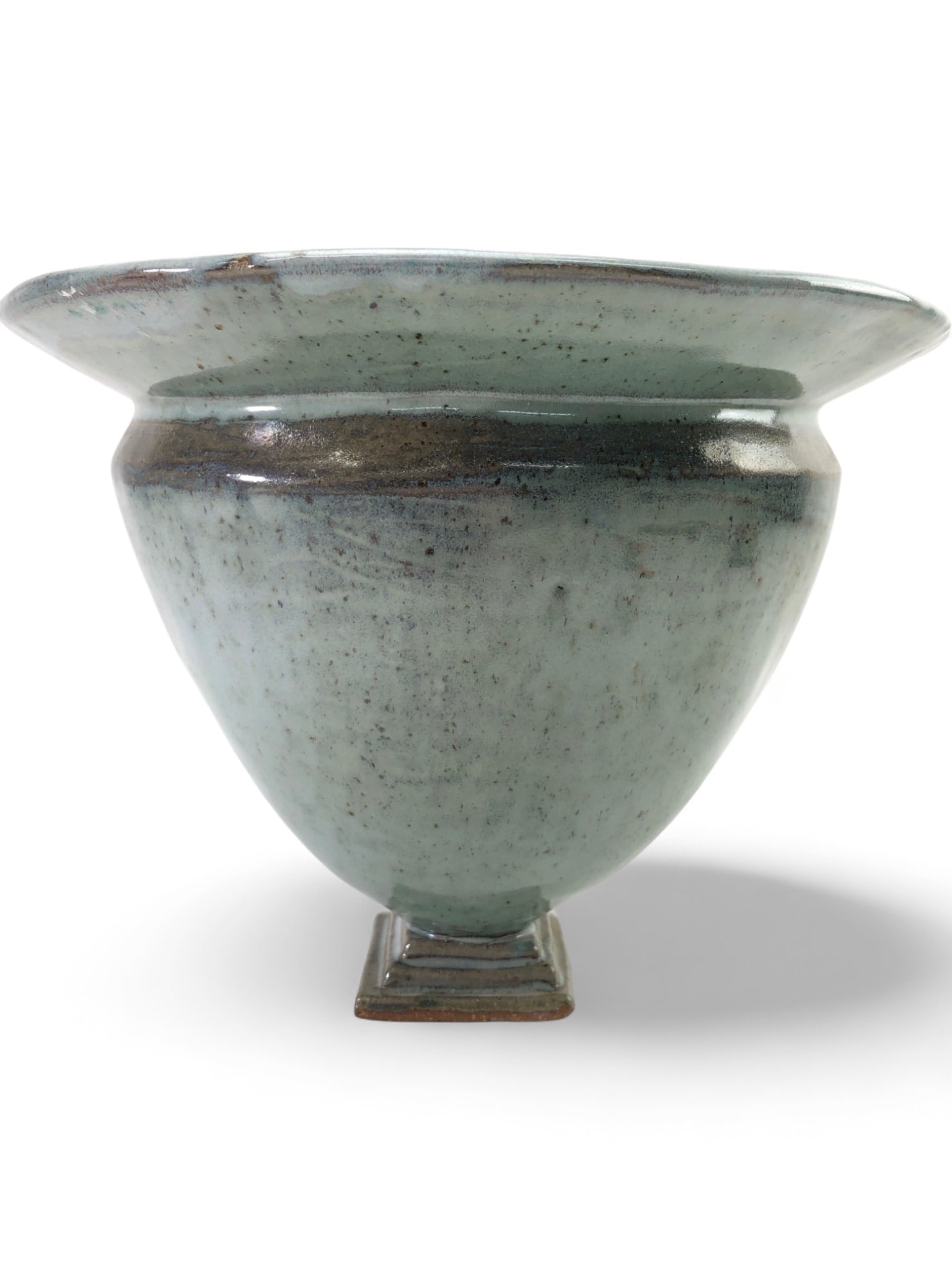 MAZ Signed Studio Art Pottery Centerpiece Planter: Large studio art pottery centerpiece planter or bowl, featuring a flared rim and a square pedestal base. The piece is finished in a speckled light blue-green celadon style glaze with a dark brown band