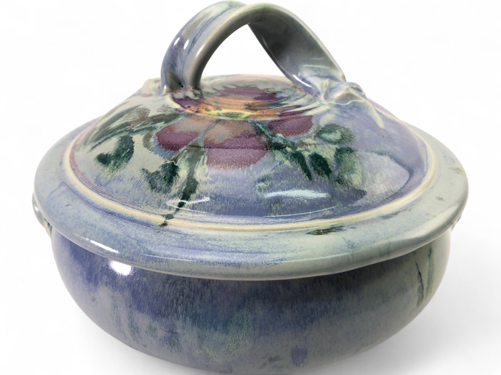Joyce Studio Art Pottery Signed Lidded Serving Dish: A signed studio art pottery lidded serving dish by Joyce. This stoneware piece features a hand-painted floral motif in shades of purple, green, and blue with a high-gloss glaze. The lid includes a