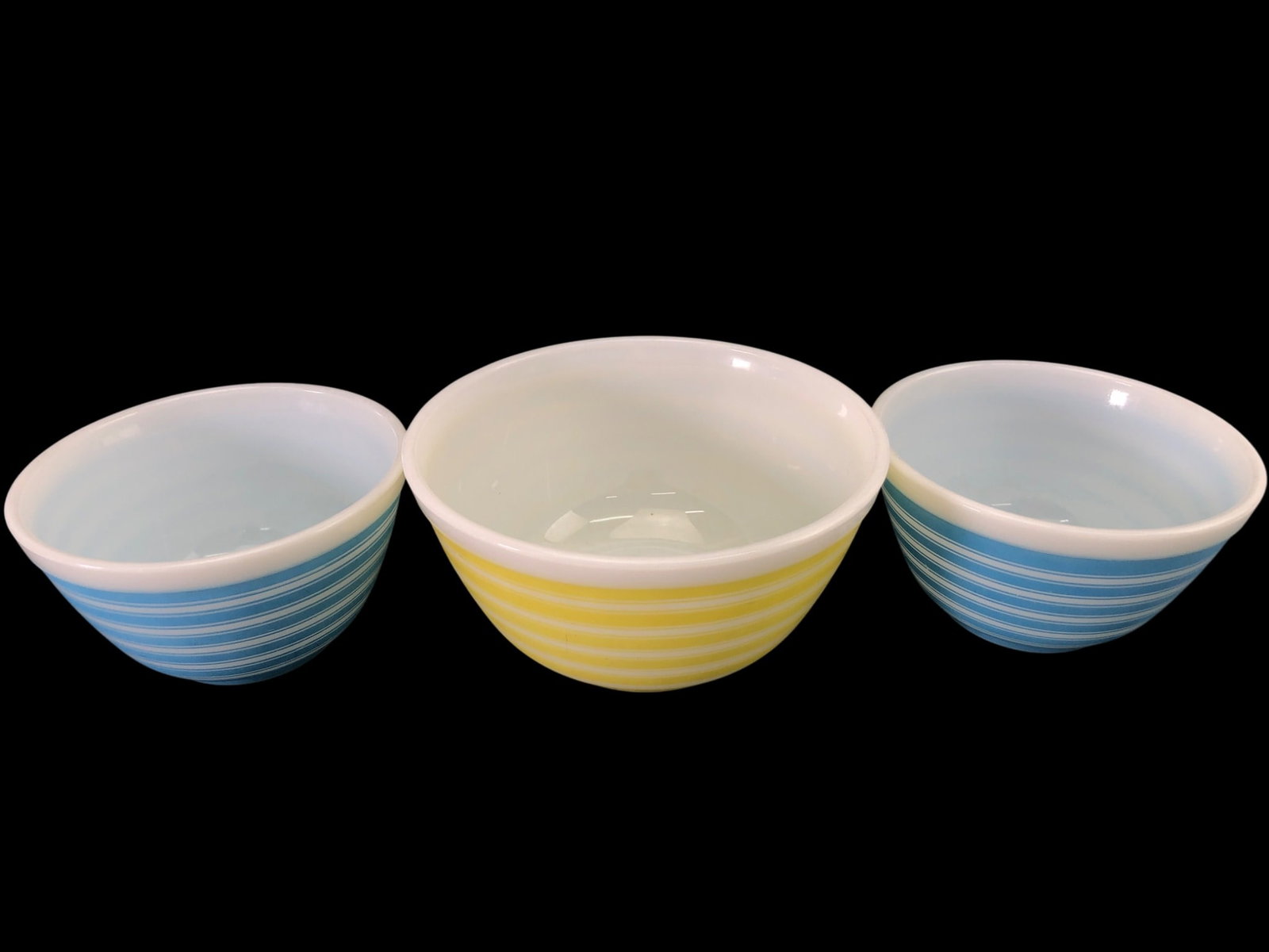 Rare Pyrex Rainbow Stripe Mixing Bowls, Set of 3: Set of three vintage Pyrex nesting mixing bowls in the rare Rainbow Stripe pattern, produced circa 1965-1967. Includes two blue striped bowls (model 401, 1.5 pt) and one yellow striped bowl (model 402