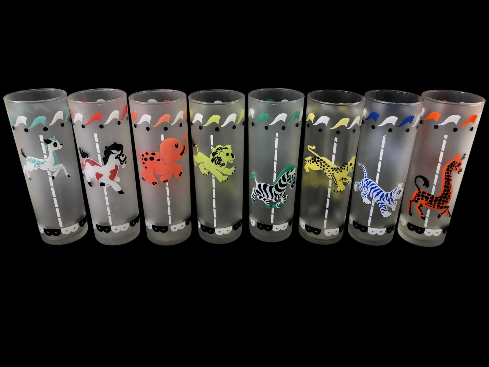 VTG Libbey Carousel Circus Frosted Tumbler Glasses: Set of eight vintage frosted Tom Collins glasses by Libbey. Each glass features a colorful carousel animal motif including a deer, horse, elephant, lion, zebra, leopard, tiger, and giraffe. The