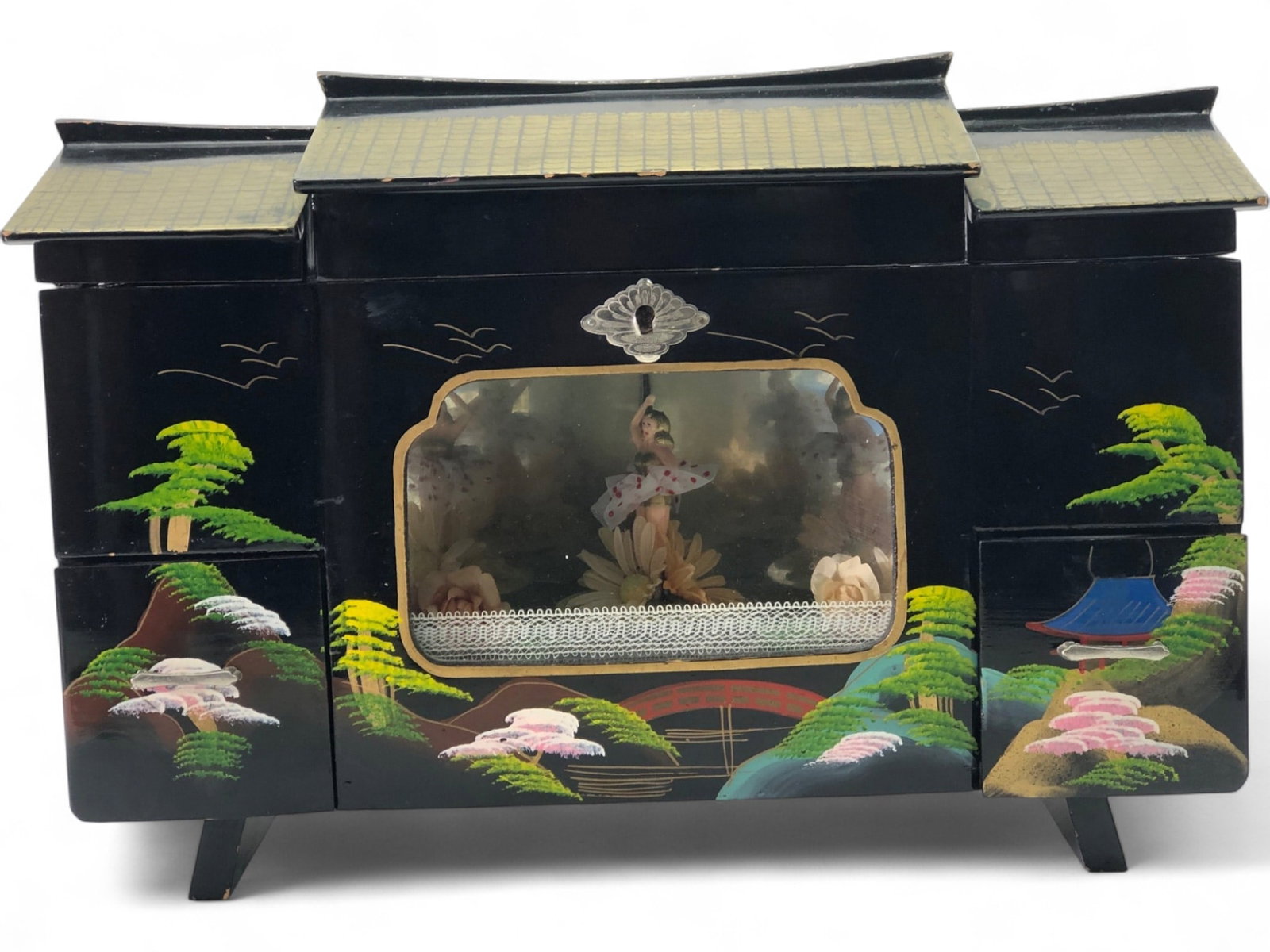 VTG Japanese Lacquer Jewelry Music Box: A vintage Japanese lacquer jewelry music box. Crafted from black lacquered wood, it features hand-painted scenic designs of trees, birds, and a bridge. The box includes multiple pink velvet-lined