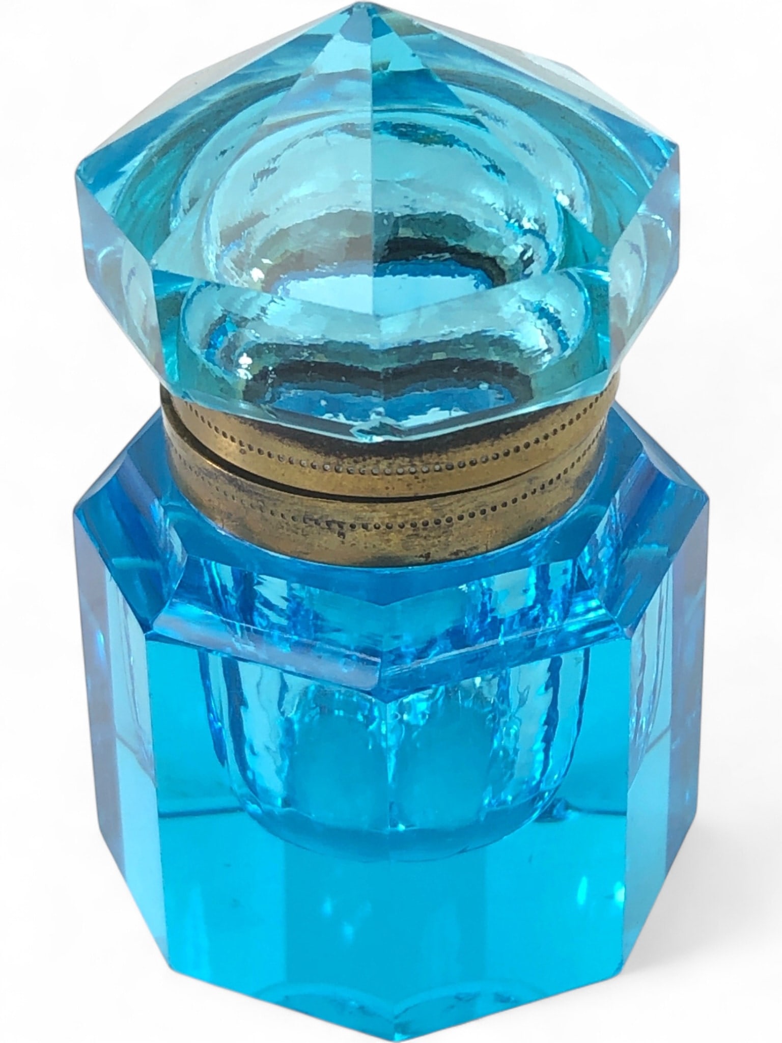 Antique Blue Crystal Art Deco Style Inkwell: Antique Art Deco style inkwell crafted from faceted blue crystal, featuring an octagonal body and a matching faceted lid. The lid is secured by a hinged brass collar, showing age-appropriate patina an