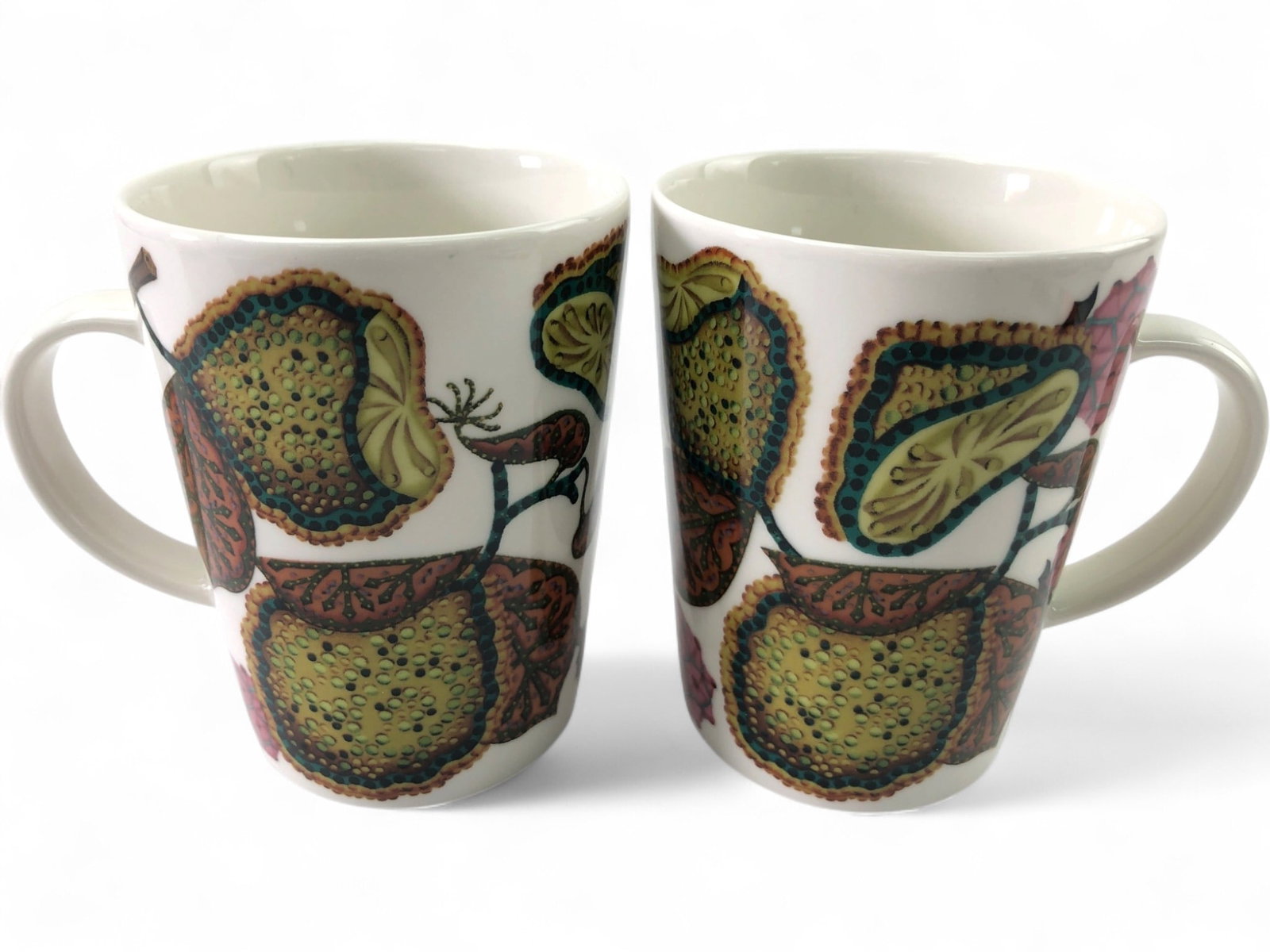 Iittala Taika Soto Porcelain Mug Set of 2: Pair of Iittala, Finland Taika Soto durable porcelain mugs, designed by Heikki Orvola. Each mug features a vibrant botanical pattern with green, brown, and pink hues. Marked 'iittala' and 'Dishwasher,
