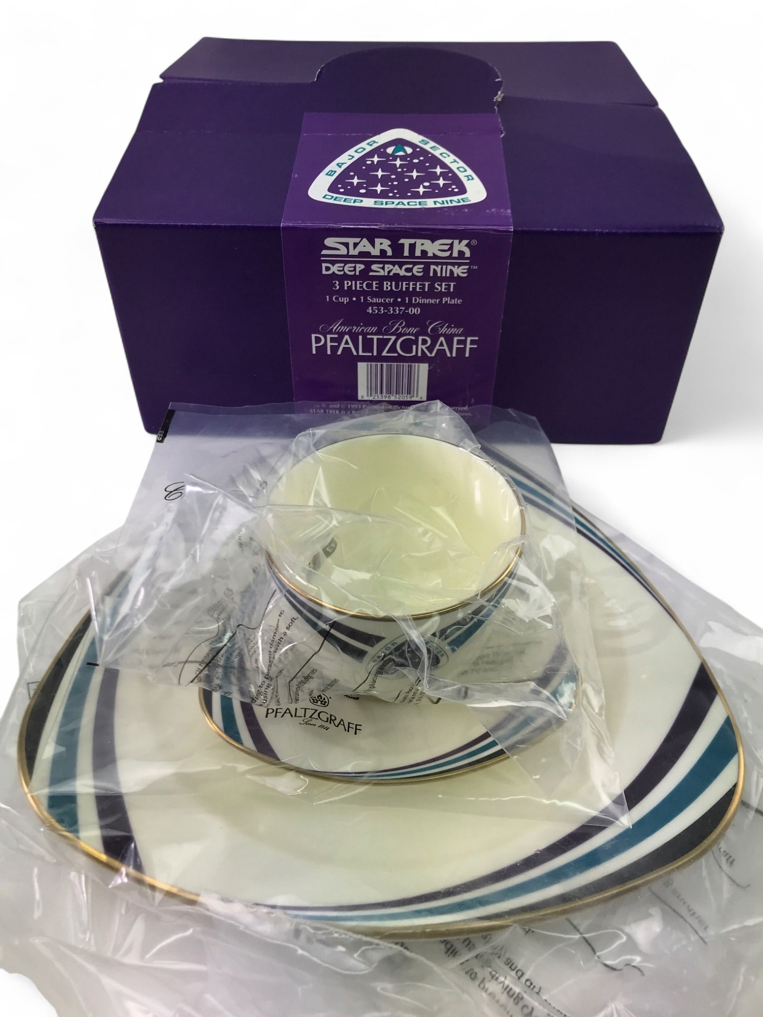 VTG NIB Pfaltzgraff Star Trek DS9 3pc Buffet Set: VTG NIB Pfaltzgraff Star Trek Deep Space Nine 3-piece buffet set, crafted from American Bone China. Features the 'Bajor Sector' logo, blue, purple, and black stripes with gold trim. Set includes 1 cup