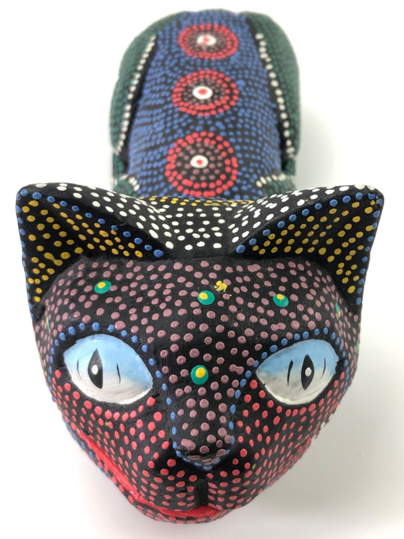 Balinese Handcarved Dot Art Cat Trinket Box: Balinese handcarved wood cat trinket box, 8" long. Features vibrant dot art painting in various colors on a black ground. The head serves as a hinged lid, revealing a red-painted interior. Folk art st