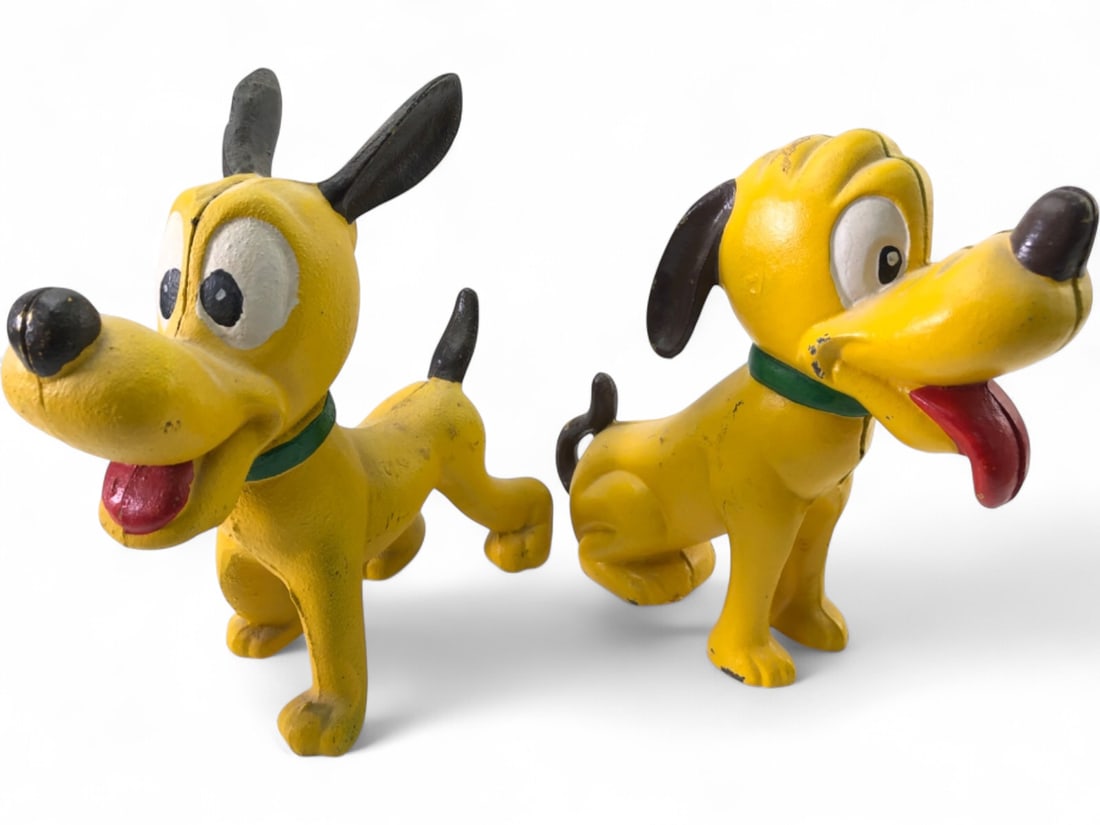 Disney Cast Iron Pluto Coin Banks, pr.: Pr. vintage cast iron Pluto coin banks, depicting the iconic Disney character. One standing, one sitting, both painted yellow with black ears, noses, and tails, green collars, and red tongues. Coin sl