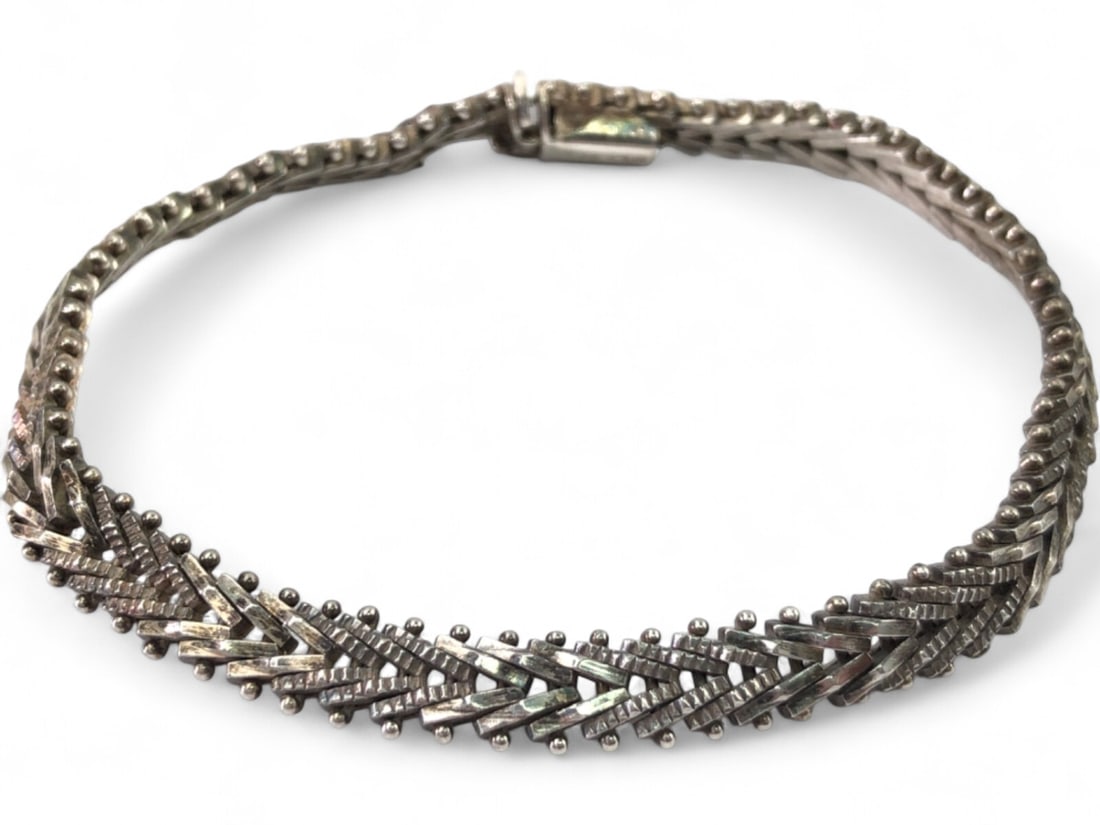 Mexican Sterling 925 Woven Bracelet: Mexican Sterling 925 Woven Bracelet, crafted in Mexico. This bracelet features a wide, flat woven design with textured details and small spherical accents. Secures with a box clasp. Marked 'MEX 925'