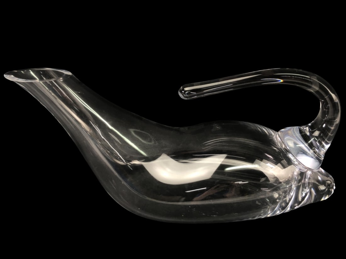 Riedel Crystal Duck Wine Decanter: Hand-blown Riedel crystal Duck wine decanter. This elegant piece features a sleek, elongated body with a curved handle and an angled spout for precise pouring. Unmarked. Measures 13" long. Excellent
