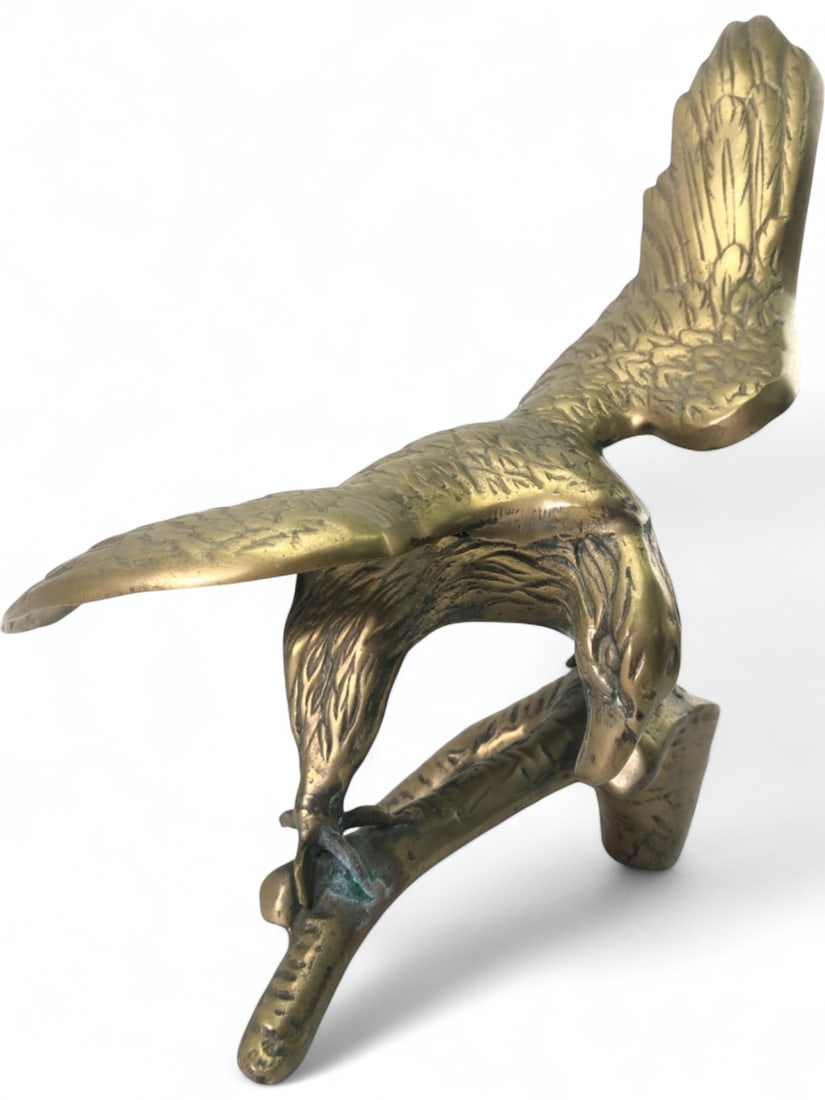 Vintage Brass Eagle on Branch Figurine: Cast brass figurine depicting an eagle with outstretched wings perched on a branch. The piece features detailed feathering and a naturalistic pose. Unmarked. Shows areas of verdigris oxidation and