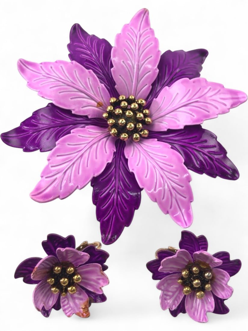 Vintage Enamel Flower Brooch and Earring Set: Vintage costume jewelry set featuring a large 3.25" wide layered flower brooch and matching clip-on earrings. Constructed from purple and lavender enameled metal with gold-tone textured centers. Unmar