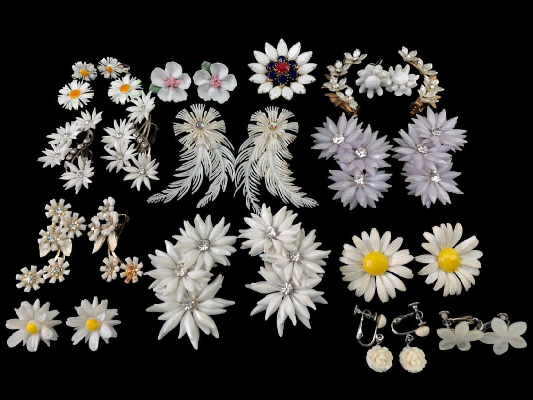 Coro and West Germany Vintage White Floral Jewelry: Large collection of vintage white floral costume jewelry, including clip-on and screw-back earrings and a brooch. Features pieces marked Coro and West Germany. Materials include molded plastic, enamel