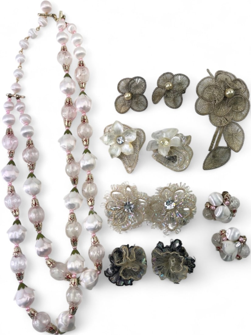 Vintage Floral Costume Jewelry Lot: A collection of vintage floral-themed costume jewelry including a double-strand necklace with pink and white satin-finish beads, four pairs of clip-on earrings featuring lace, mesh, and rhinestone det