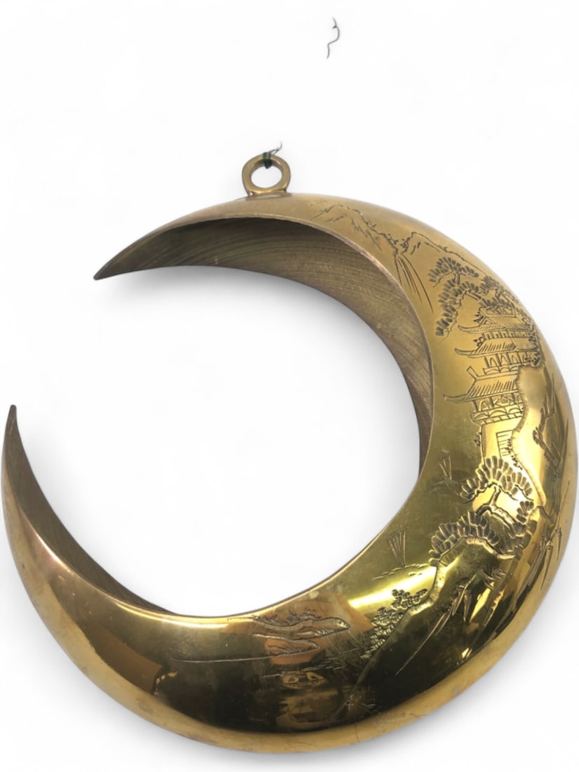 MCM Brass Etched Crescent Moon Hanging Planter: Mid-Century Modern brass hanging planter in the shape of a crescent moon. Features an etched Asian-inspired landscape motif with pagodas, pine trees, and mountains. The interior includes a metal grid 