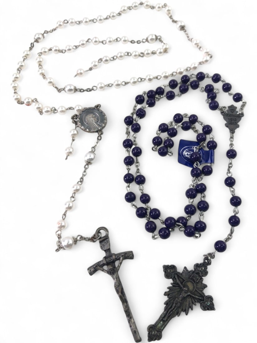 Two Catholic Rosaries, Fatima Centenary and Faux Pearl: Lot of two Catholic rosaries. Includes a purple beaded rosary commemorating the Fatima Centenary (1917-2017) with a Sacred Heart center medal and ornate crucifix. The second rosary features white faux