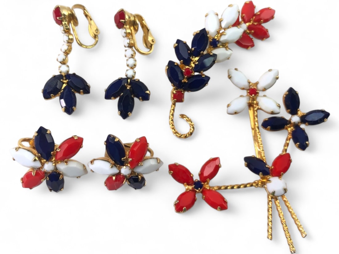 Vintage Red White and Blue Rhinestone Jewelry Set: 6 piece costume jewelry set featuring patriotic red, white, and blue marquise-cut rhinestones set in gold-tone metal. Includes a floral spray brooch, a leaf-motif brooch, one pair of floral cluster cl