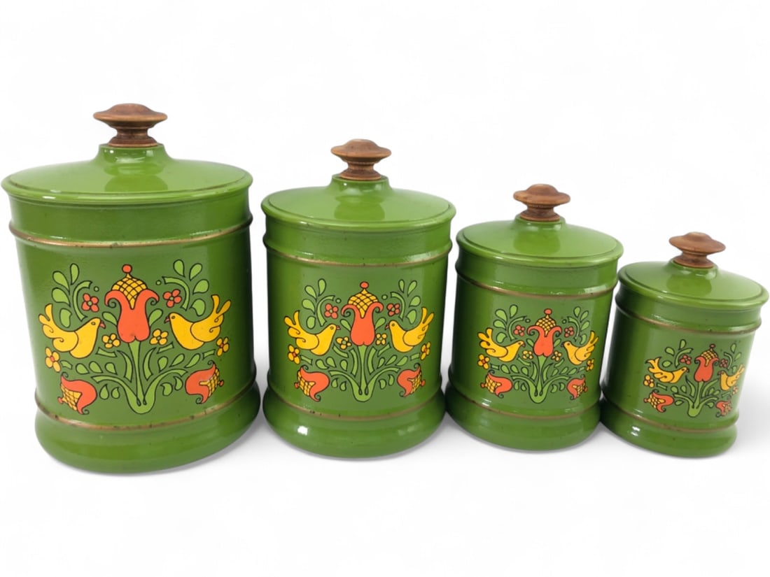 VTG Kromex Metal Canister Set with Lids: Set of four vintage metal kitchen canisters by Kromex. Each features a vibrant green finish decorated with a colorful folk-art motif of birds and flowers in yellow, orange, and red. Topped with wooden