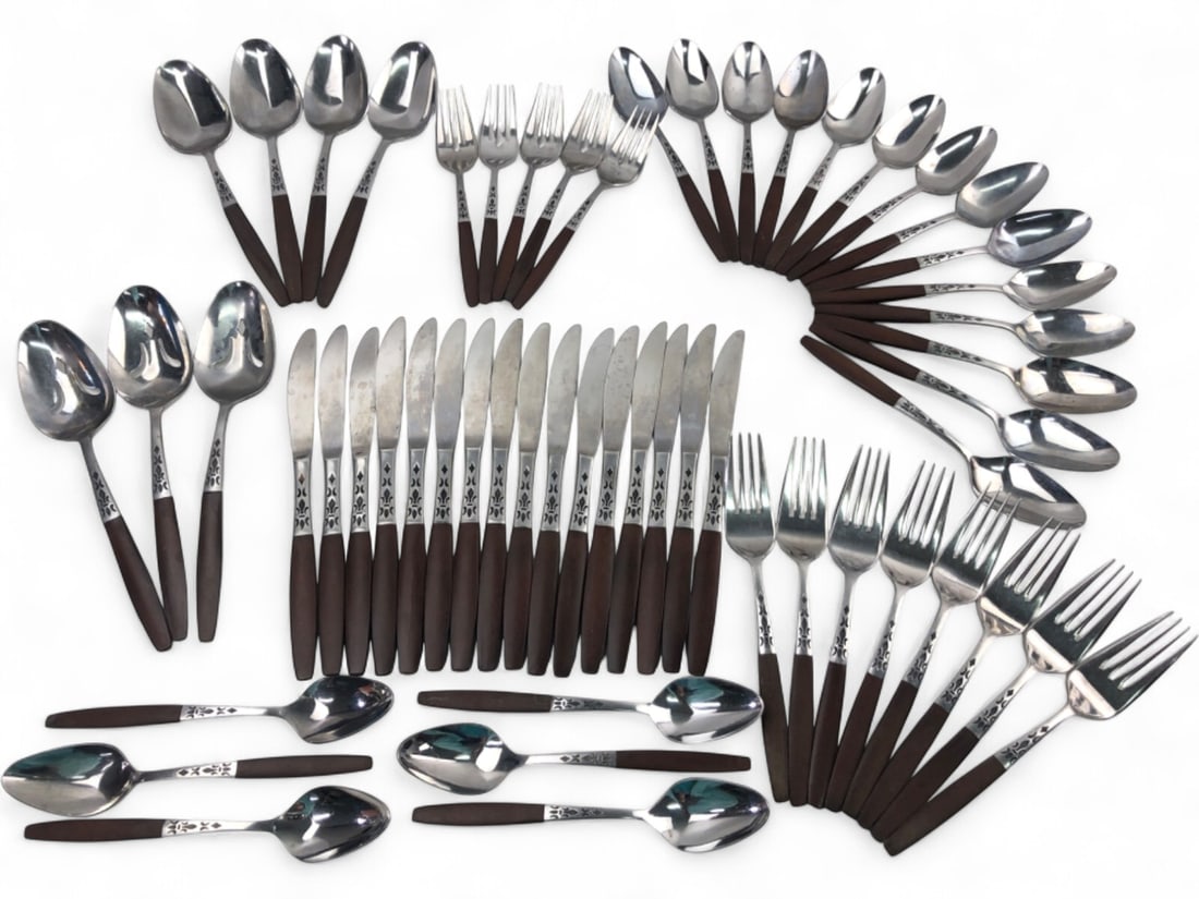 Grand Prix Forged Stainless Japan Flatware Set: A 56-piece flatware set by Grand Prix, featuring forged stainless steel construction with dark brown composite handles. The design includes a decorative fleur-de-lis style motif on the bolsters. Set i