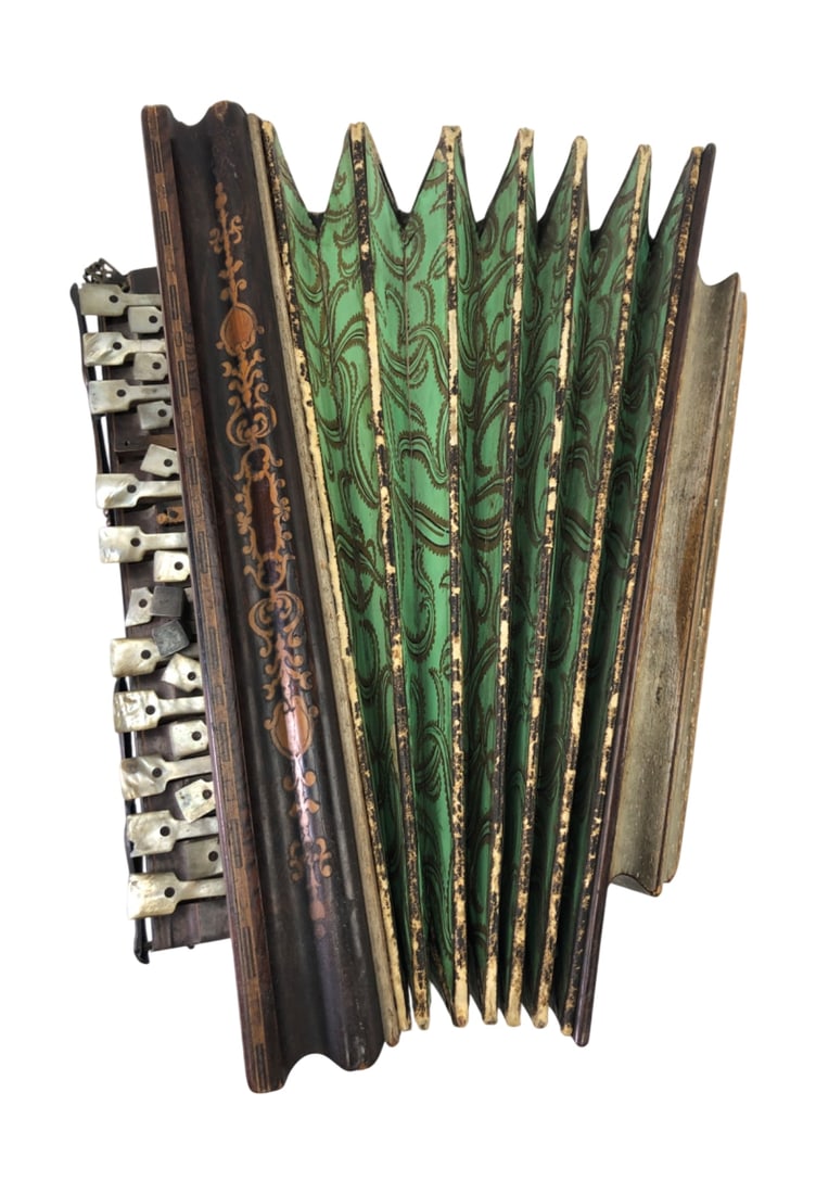 Antique French Flutina Accordion: Antique French flutina accordion featuring a dark wood case with inlaid floral and scrollwork motifs. The instrument is equipped with mother-of-pearl keys and buttons, and green patterned paper