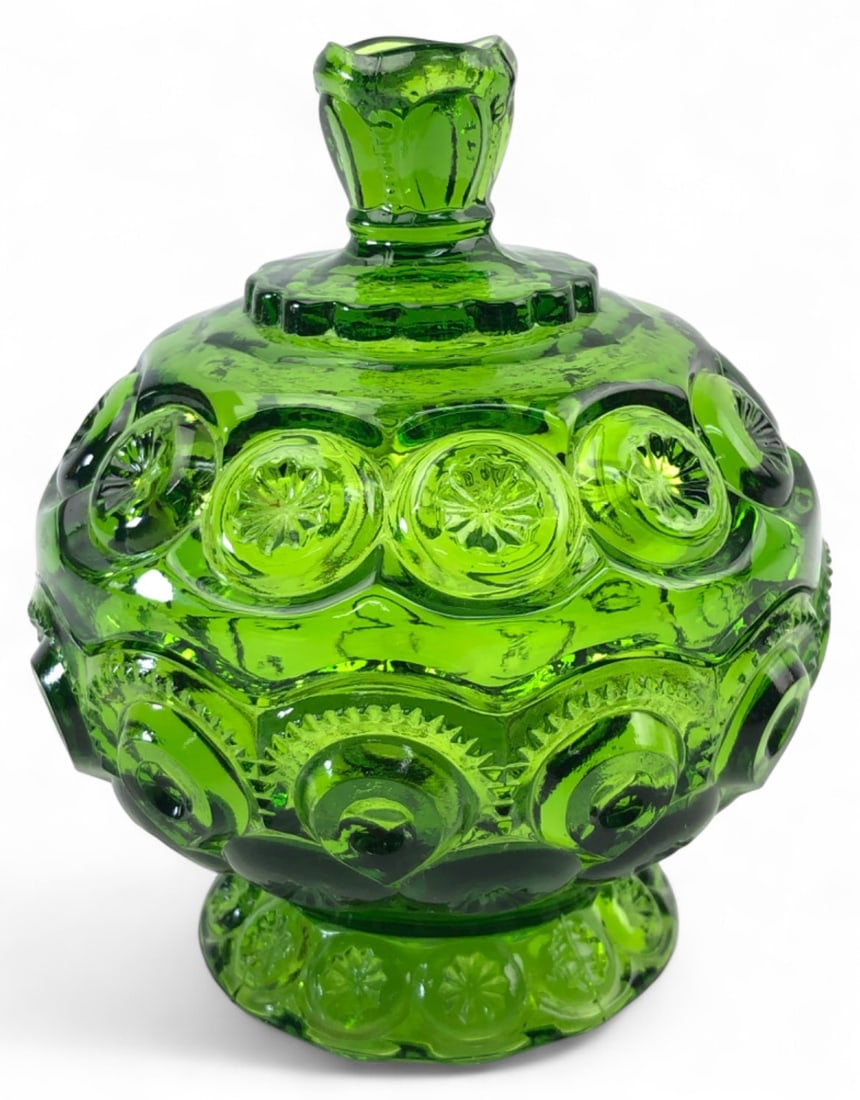 MCM Moon & Stars Emerald Green Covered Candy Dish: Emerald green pressed glass covered candy dish in the Moon & Stars pattern. Features a lidded design with a decorative knob and star-and-moon motifs throughout. 6" H.