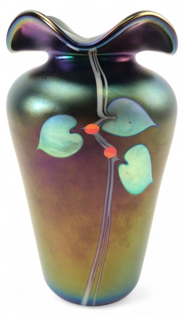 Stuart Abelman Signed Art Glass Iridescent Vase: Iridescent art glass vase by Stuart Abelman, featuring a heart and vine motif with orange accents on a dark, lustrous ground. The piece has a ruffled rim and a tapered form. Signed 'Abelman',