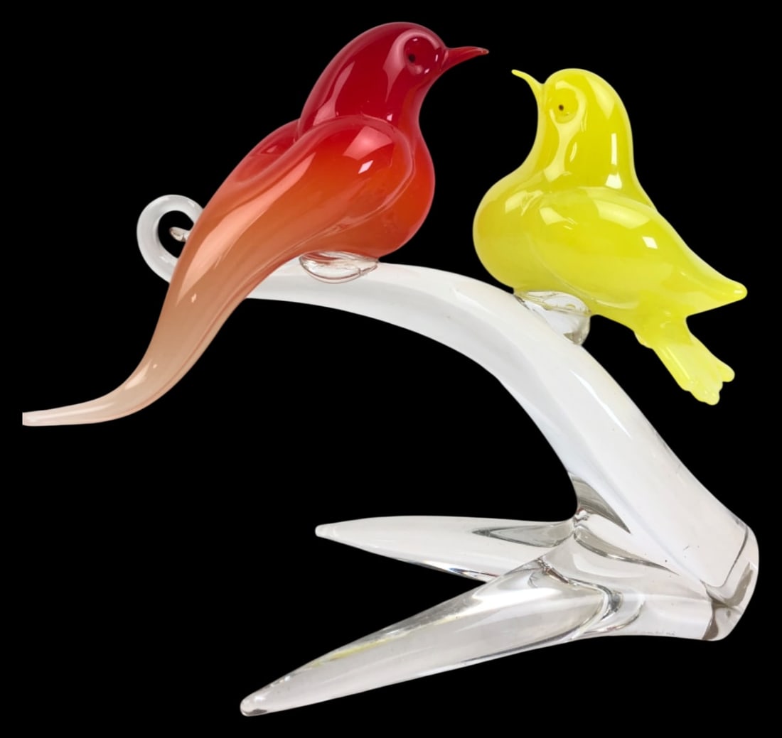 Murano Art Glass Two Birds on a Branch Figurine: Murano hand-blown art glass figurine featuring two birds perched on a clear glass branch. One bird is vibrant red with an orange-tinted tail, and the other is bright yellow. The piece is mounted on a