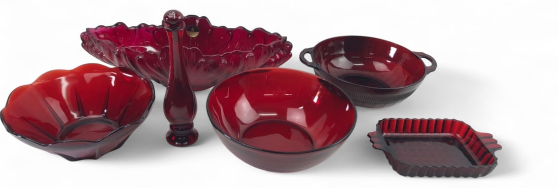 Jeannette and Avon Red Pressed Glassware Collection: Collection of six red pressed glassware pieces. Includes a large Jeannette Glass oval bowl with scalloped rim and original foil label, an Avon bud vase with stopper, a round serving bowl with