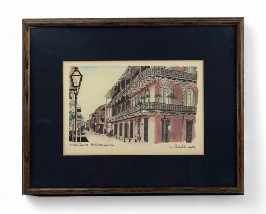 A. Denila French Quarter New Orleans Print: Framed print of the French Quarter in New Orleans, Louisiana, by artist A. Denila. The piece features a street scene with characteristic wrought-iron balconies and a gas lamp. Signed (printed) and
