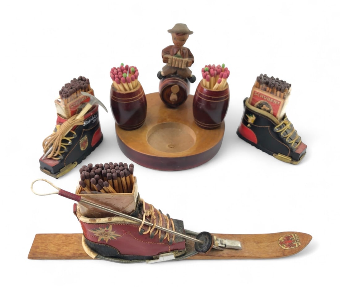 Tirol Souvenir Match Holder and Ashtray Set: Group of 4 hand-painted wooden and leather souvenirs from the Tirol region of Austria. Includes a wooden ashtray stand with a musician figure and match barrels, two miniature leather hiking boots