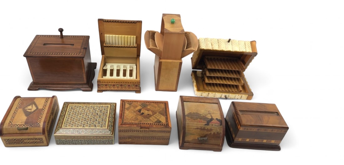 Group of 9 Marquetry and Inlaid Wood Cigarette Boxes: Collection of nine wooden cigarette and cigar boxes and dispensers. Includes various styles such as parquetry, marquetry, and inlaid designs. Features include a roll-top box with landscape scene, a