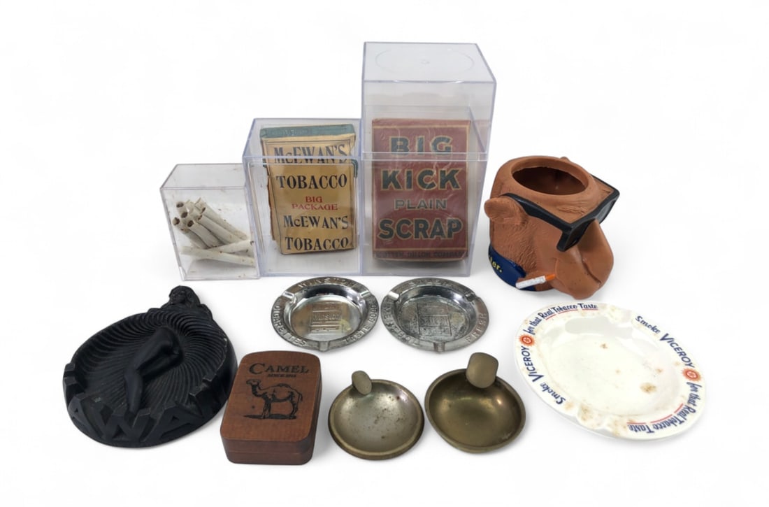 Vintage Tobacco Collectibles and Ashtrays Group: Collection of tobacco-related items including a Joe Camel character mug, vintage McEwan's and Big Kick tobacco packages in acrylic cases, a Viceroy porcelain ashtray, Winston and Salem metal