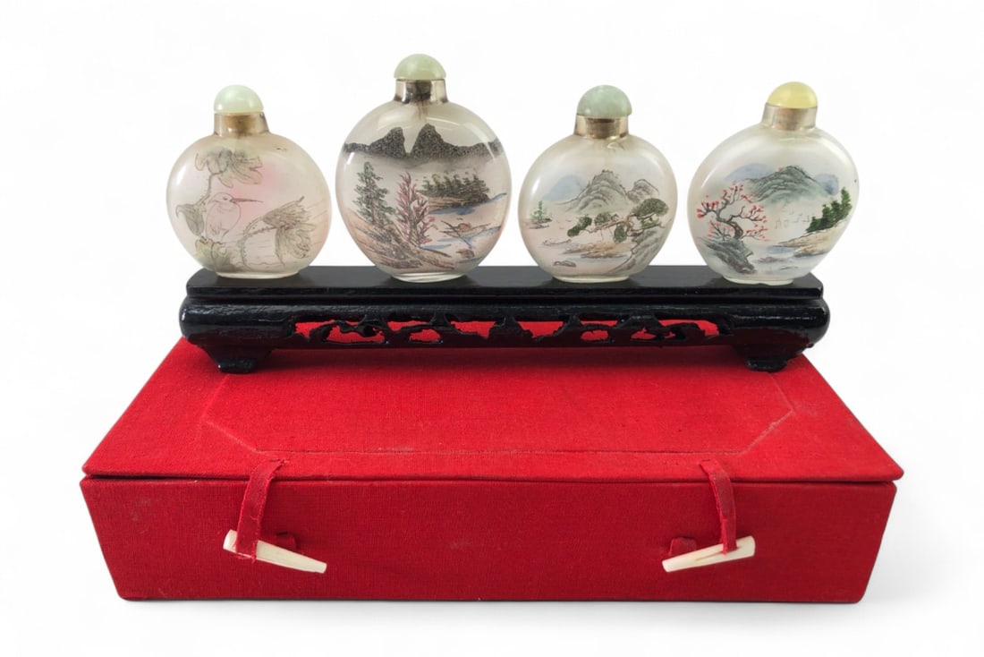 VTG Inside Hand Painted Snuff Bottles, Set of 4: Set of four vintage Chinese glass snuff bottles, each featuring intricate inside hand-painted motifs including landscapes, florals, and a bird. One bottle is marked "Inside Hand Painted By A China".