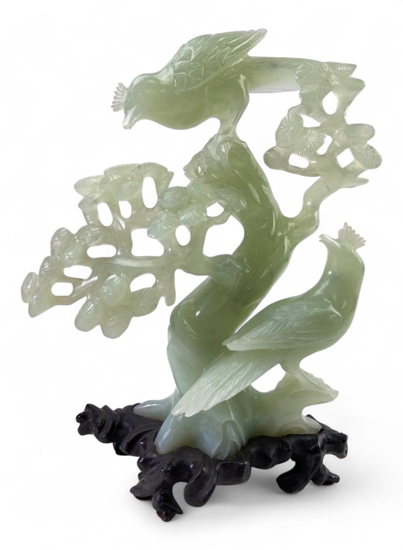 Chinese Hand-Carved Green Jade Bird Figurine: A Chinese-style hand-carved green jade figurine depicting two birds perched on a flowering branch. The piece is carved from a pale green stone with translucent qualities, featuring intricate openwork 