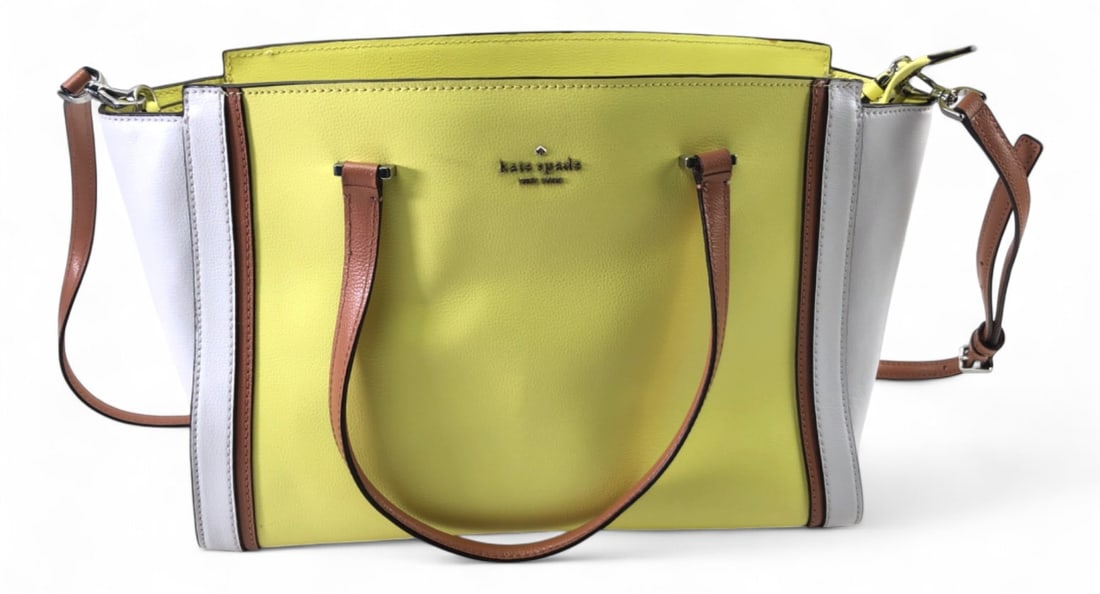 Kate Spade New York Colorblock Leather Tote Bag: Kate Spade New York colorblock tote bag in yellow, white, and brown pebbled leather. Features dual top handles, a removable adjustable shoulder strap, and a zip-top closure. The interior is lined with