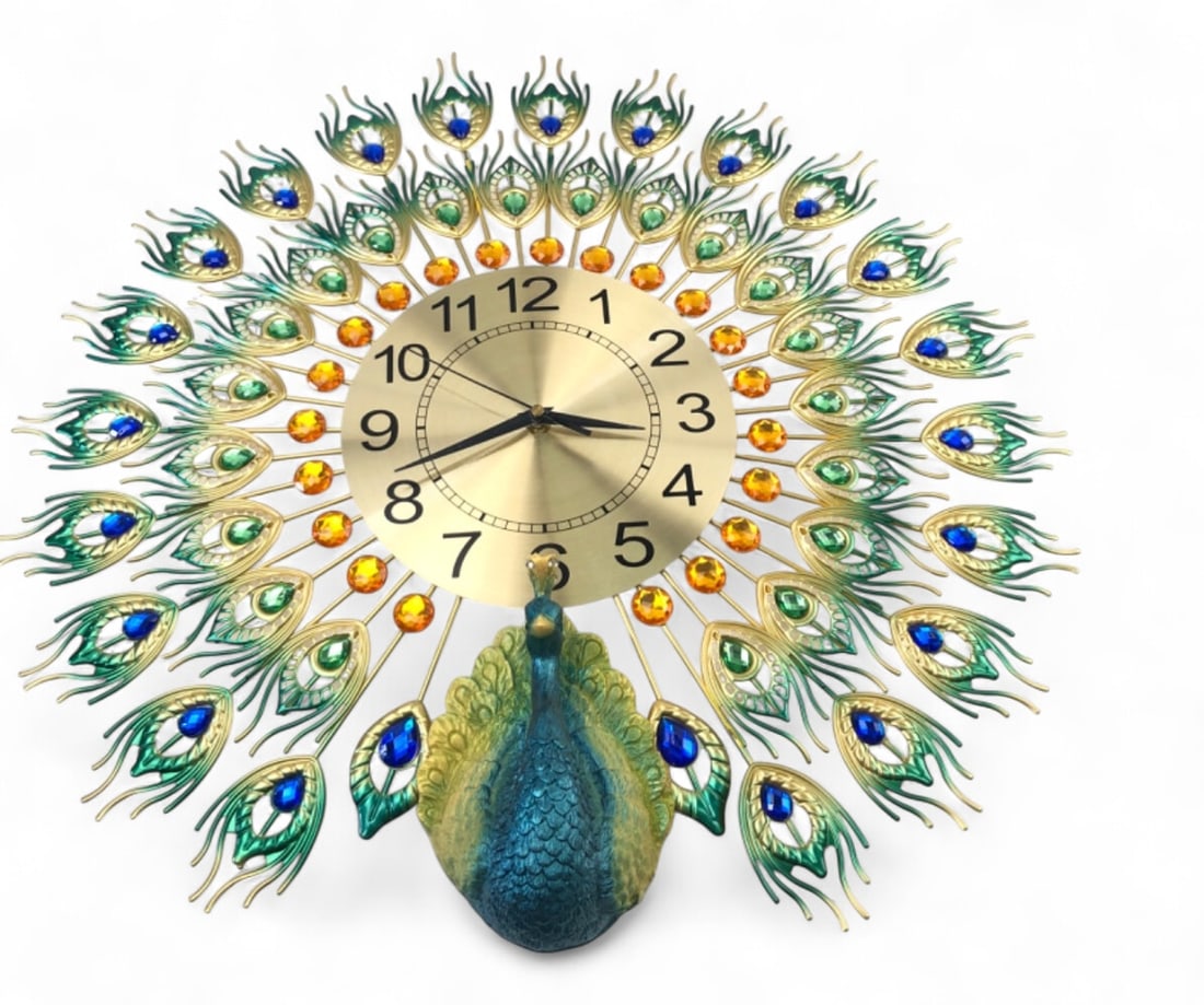 Large Rosdorf Park Bejeweled Metal Wall Clock: Peacock motif wall clock by Lianzhuang. Features a gold-tone metal sunburst frame accented with faceted orange, green, and blue acrylic gems. The base is adorned with a molded resin peacock figure in 