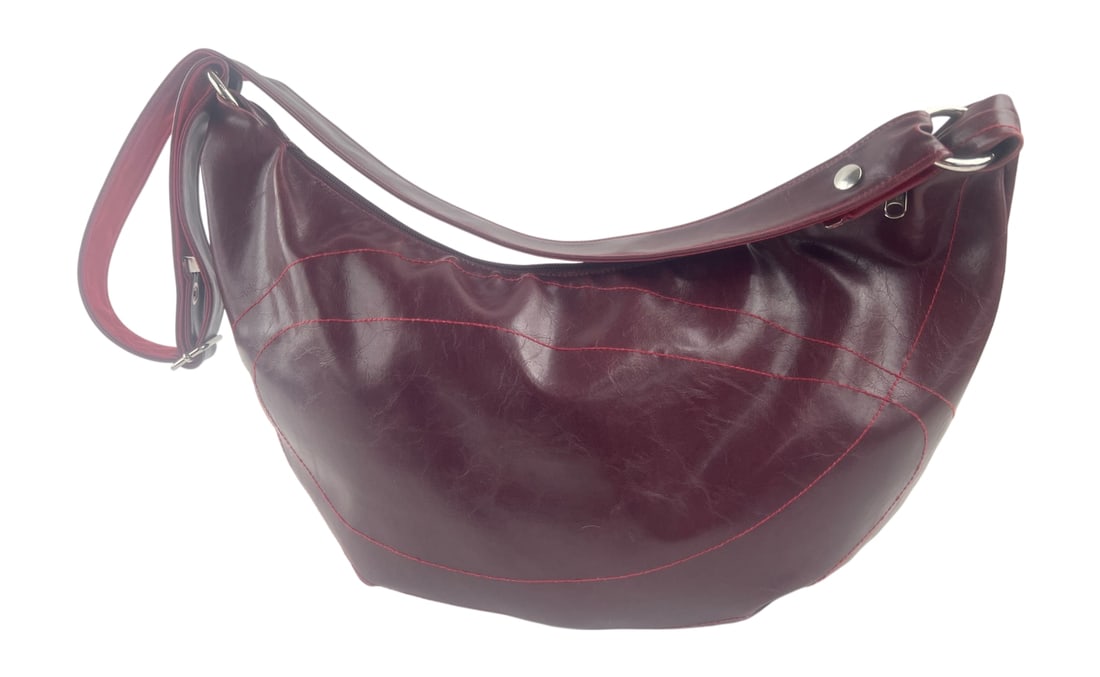 Crystalyn Kae Handcrafted Vegan Leather Hobo Bag: Handcrafted hobo-style shoulder bag by Crystalyn Kae. Features a burgundy vegan leather exterior with decorative red topstitching and a contrasting red faux-suede lining. Includes an adjustable should