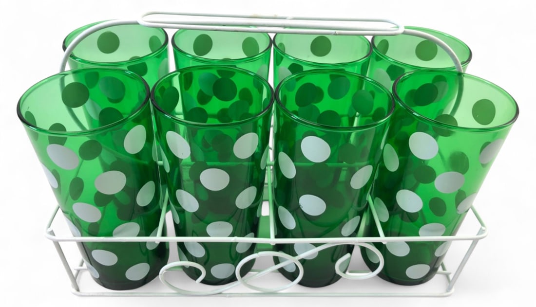 VTG Anchor Hocking Green Polka Dot Glasses & Caddy: Set of eight green glass tumblers featuring a white polka dot motif, attributed to Anchor Hocking. The set includes six tall glasses and two shorter glasses, all housed in a white-coated wire
