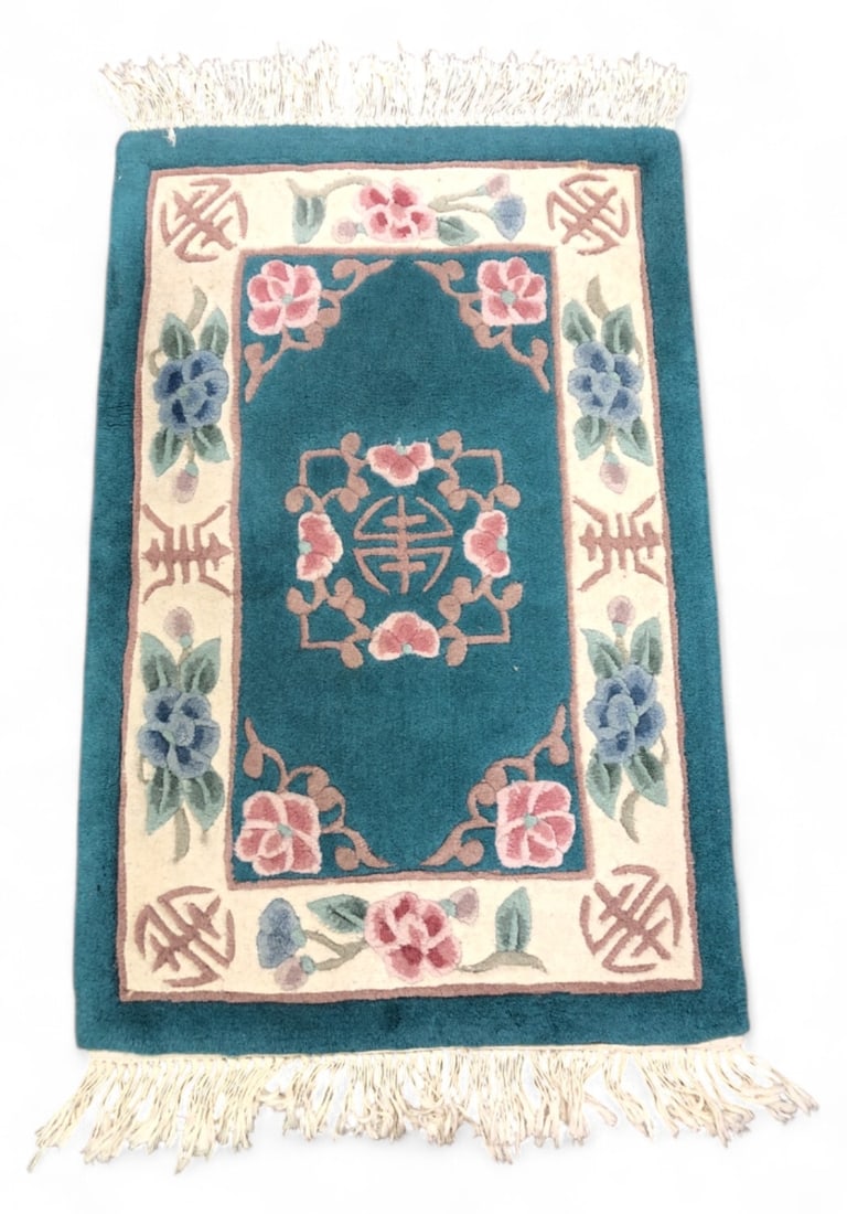 VTG Chinese Art Deco Style 100% Wool Pile Rug: VTG Chinese Art Deco style hand-knotted rug. Features a teal field with a central longevity symbol medallion surrounded by floral motifs in pink and blue. The border is cream with additional floral